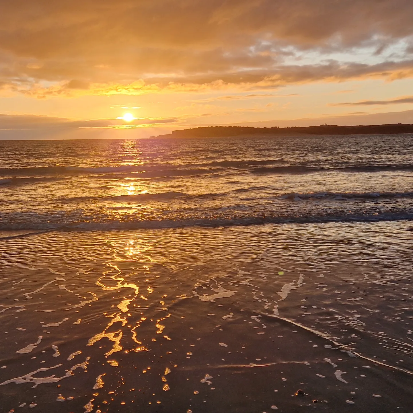 Sunset over the sea from a Tenby beach